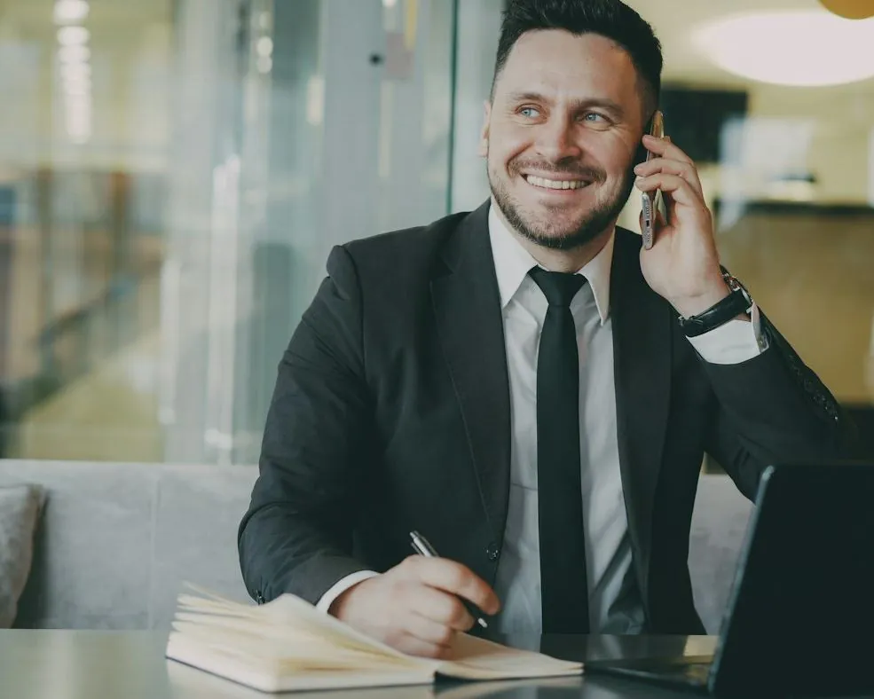 An adviser taking a call at his desk