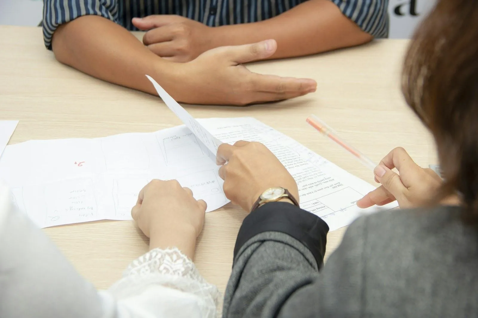 Two people reviewing documents at a table